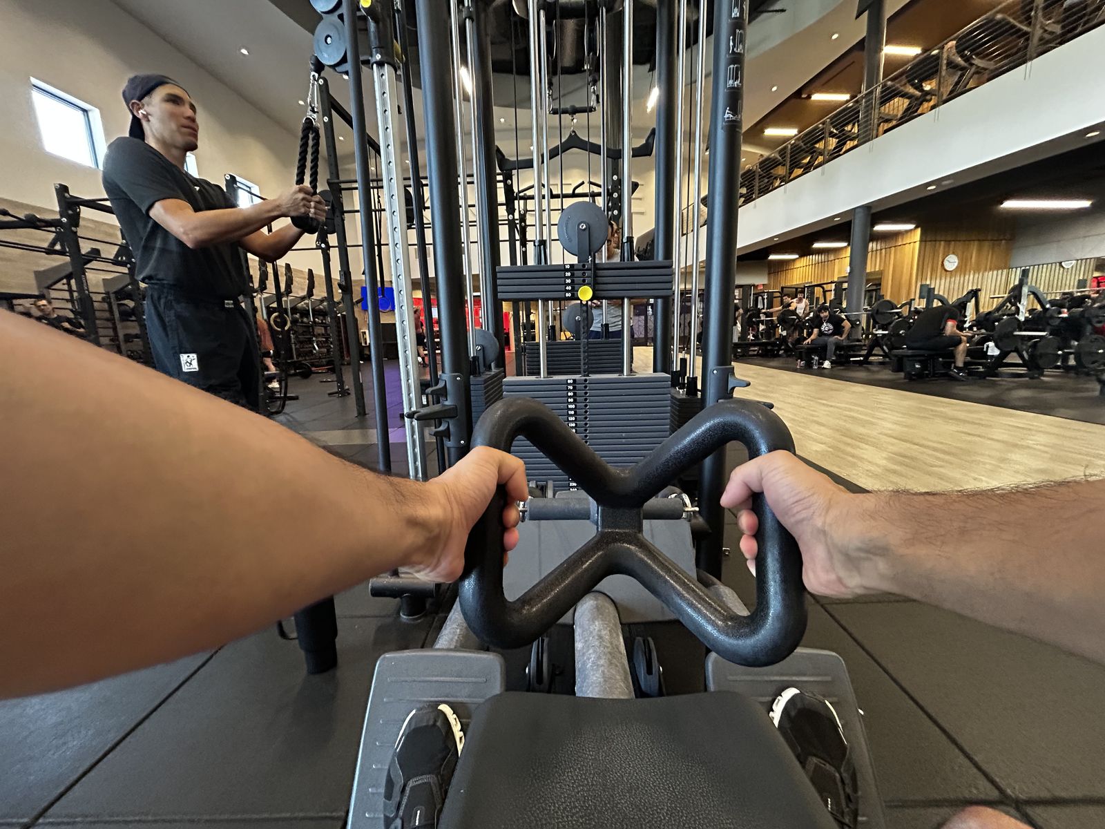 Cable exercise with trainer watching form